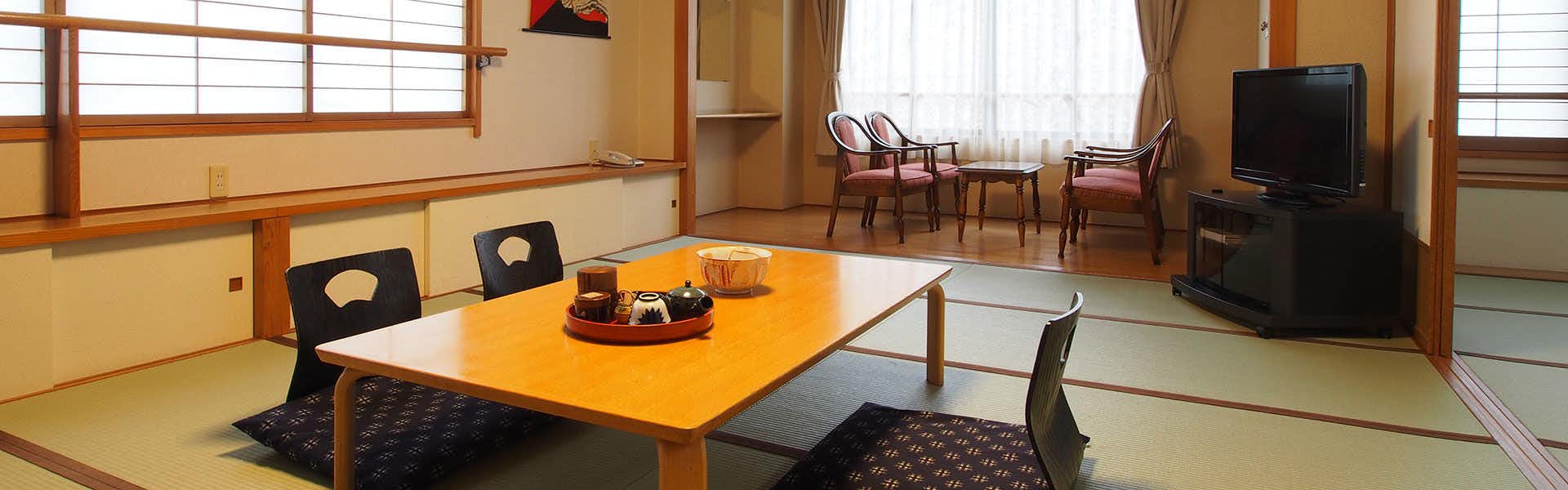 Suzunoyado Tofuya Ryokan with a traditional tatami room with low table and window seating.