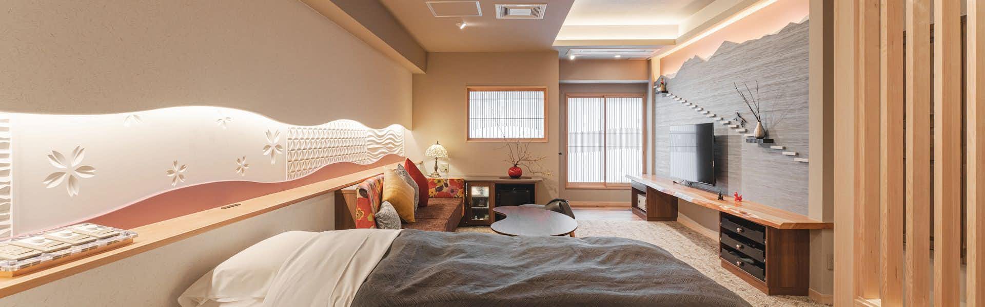 Wagokoro no Yado Omori with a modern guest bedroom with sofa and timber accents.