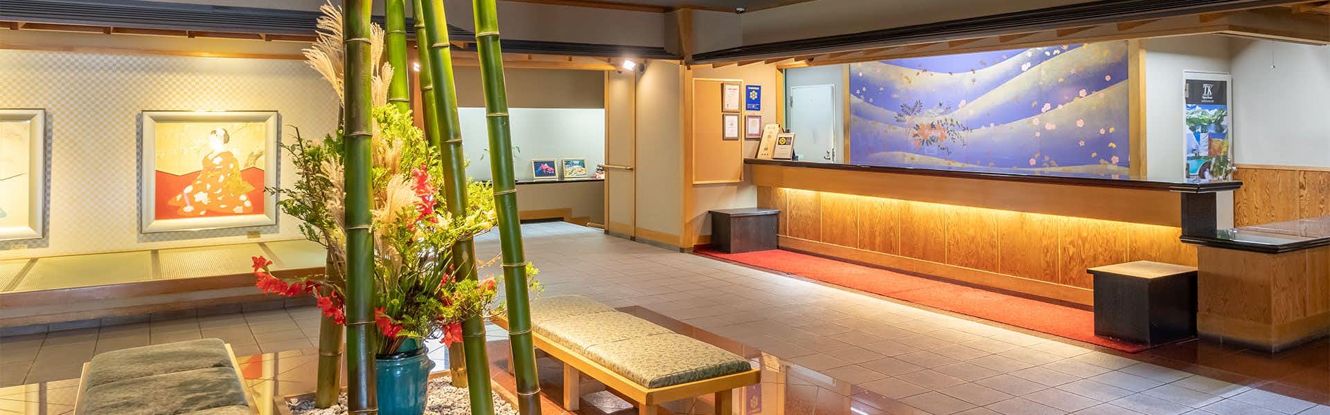 Ryokusuitei Keisui with a spacious reception lounge with timber counter and wall mural.