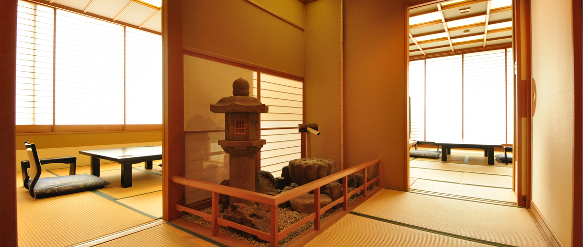 A quiet tatami guest room, shoji screens, and low seating.
