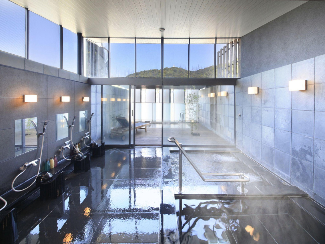 A bright bathing area with large windows.