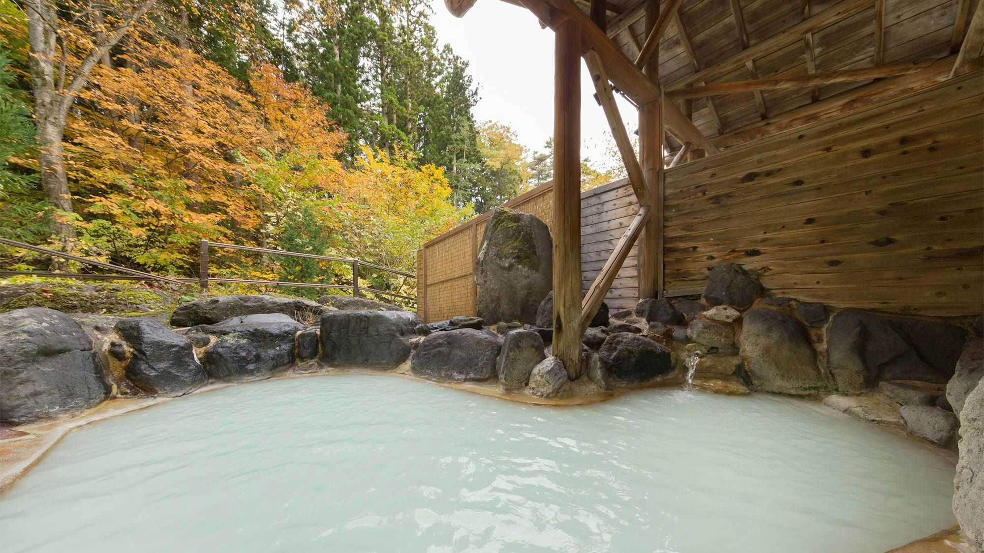 Bandai Nishimuraya with an open-air rock bath filled with cloudy mineral water.