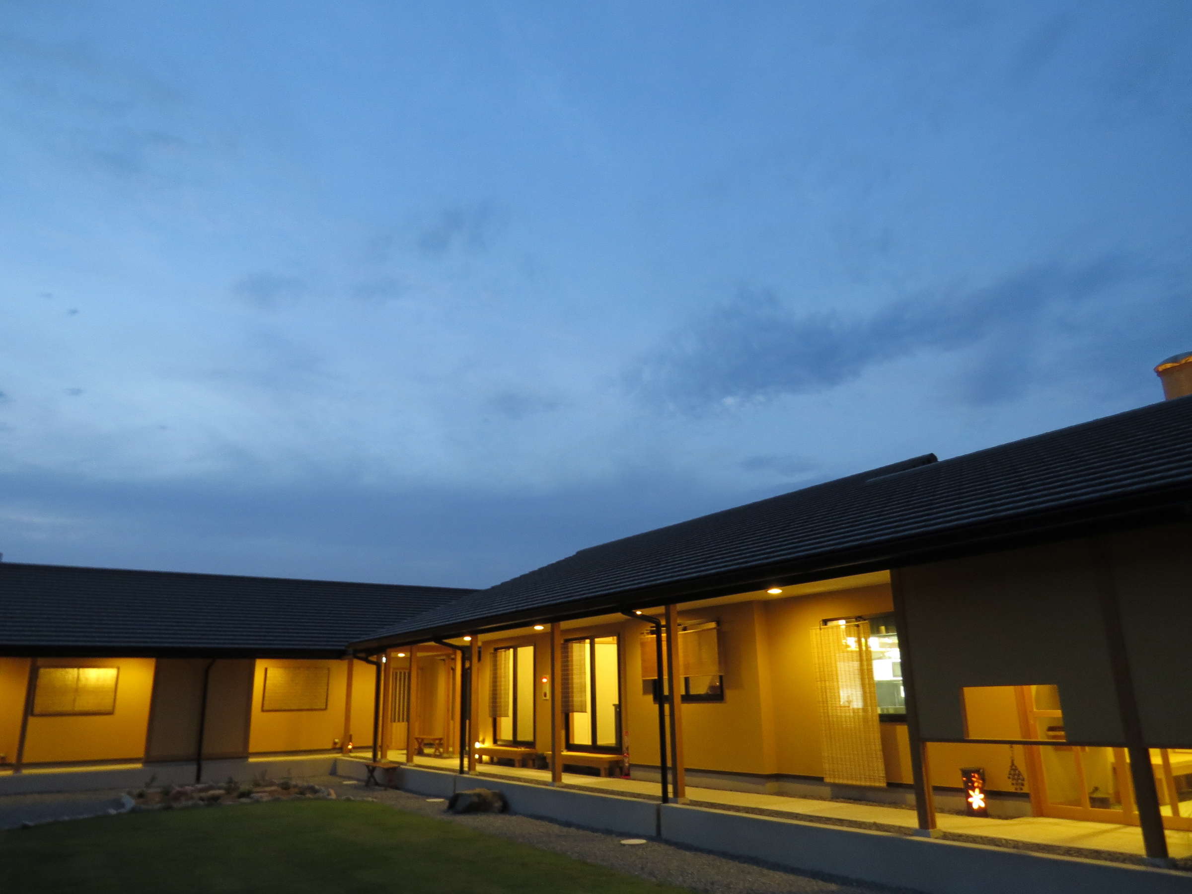 A long low building with illuminated windows.