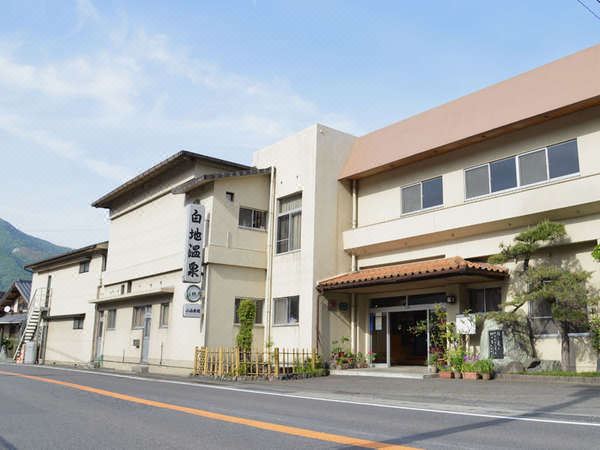 Ryokan exterior beside a road.