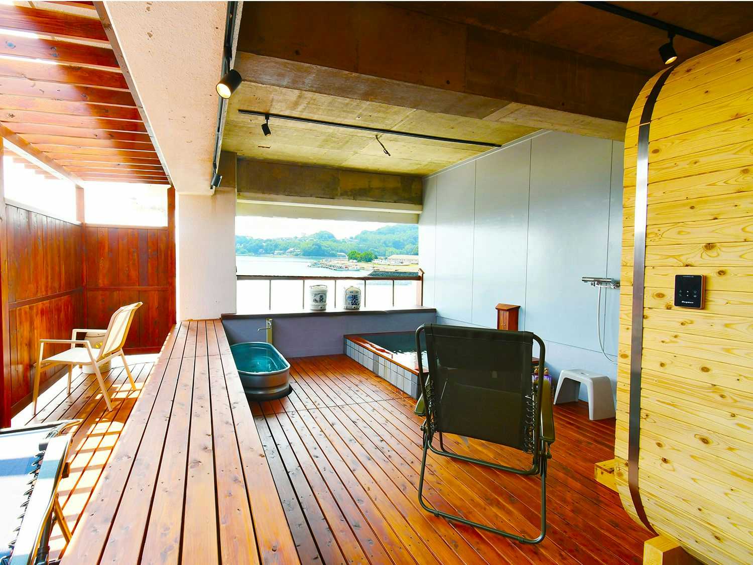 Tsuru-so Inn: Takezaki Crab and Japanese Sake with a timber balcony furnished with chairs and coastal views.