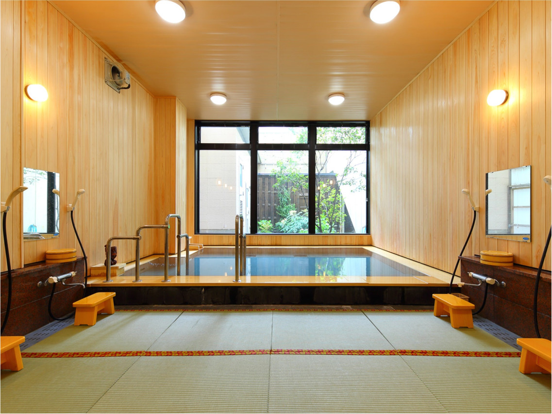 A spacious bath hall combines polished wood with large windows.