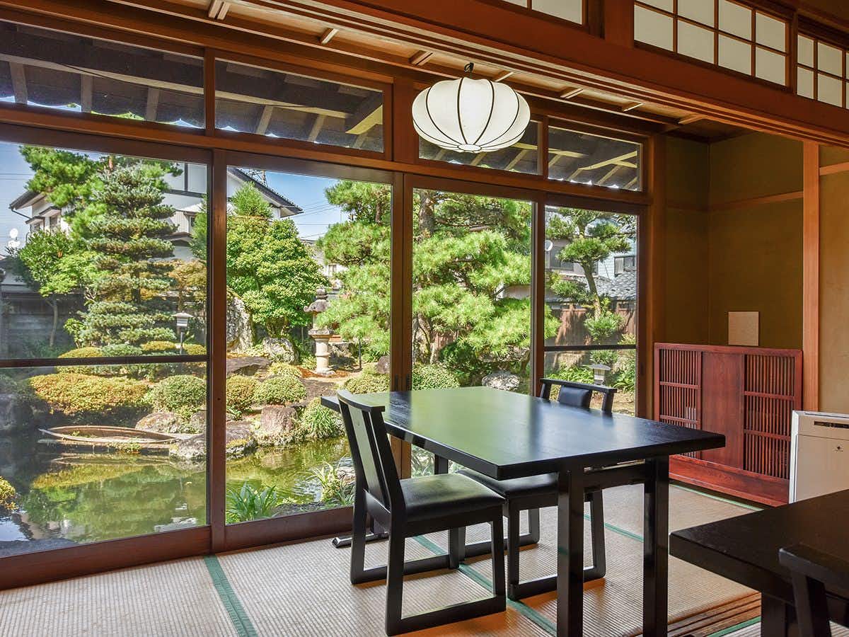 Asahi Ryokan with a garden-facing tatami room with a low dining table.