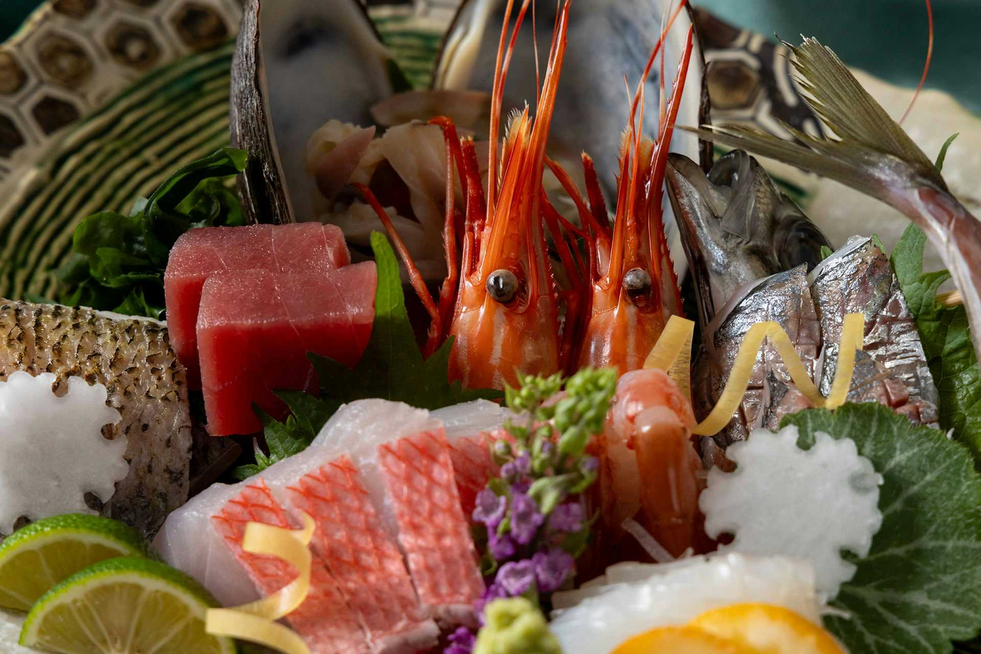 Izu-san Onsen Hotel New Sagamiya with fresh sashimi arranged with shrimp and decorative citrus.