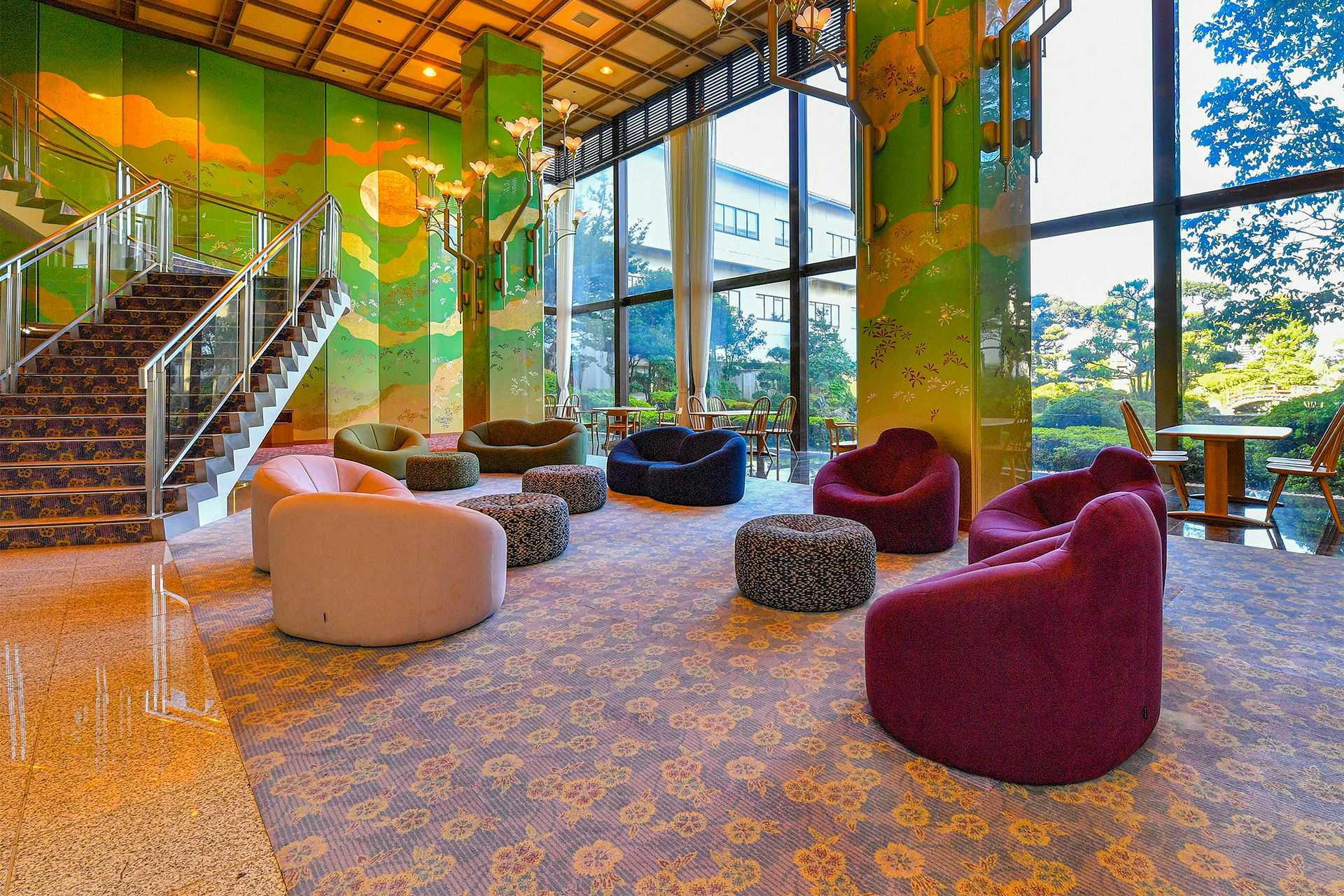 Hokuriku Fukui Awara Onsen Mimatsu with a colorful double-height lobby with garden windows and sculptural chairs.