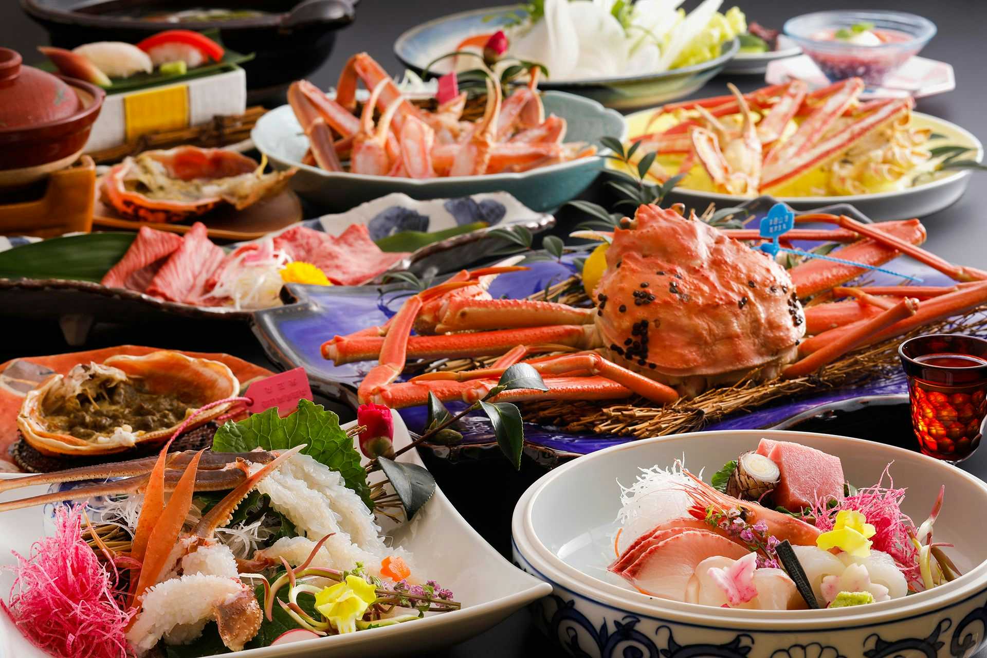 Kaikatei Hanagozen with a lavish crab dinner surrounded by sashimi and side dishes.
