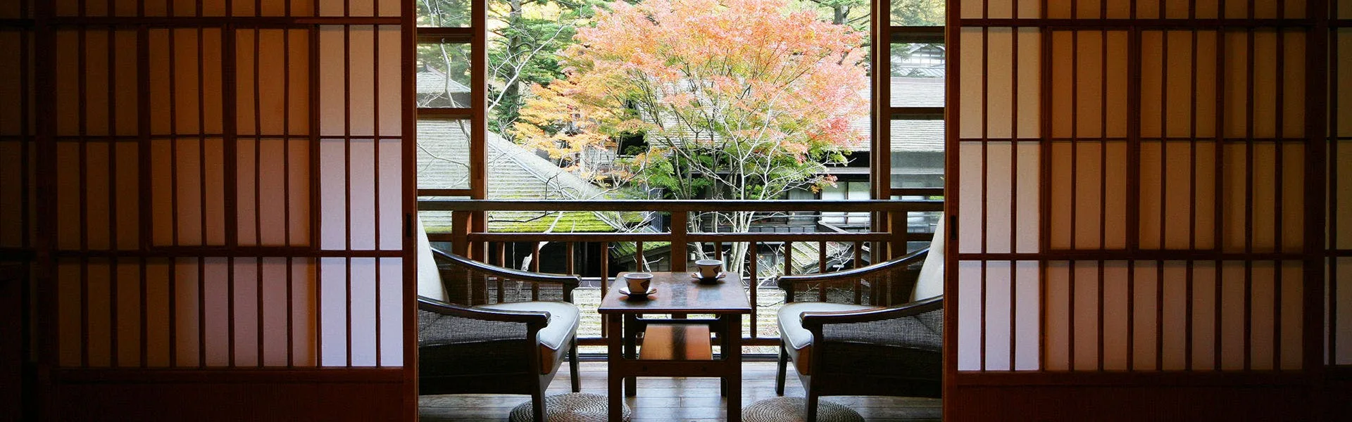 Tatami room with autumn maple view through shoji screens at Hoshi Onsen Chojukan