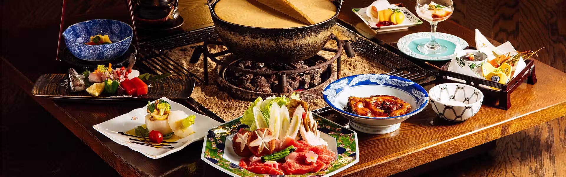 Hotel Yamabuki with this scene, where an irori dinner gathers hot pots, sliced fish and vegetables around the hearth.