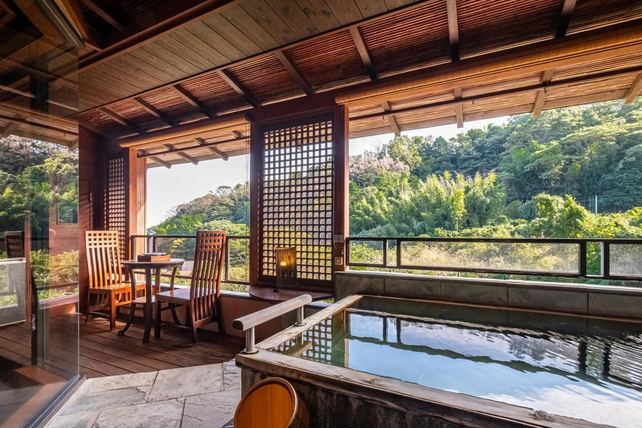 Open-air bath overlooking a wooded valley.