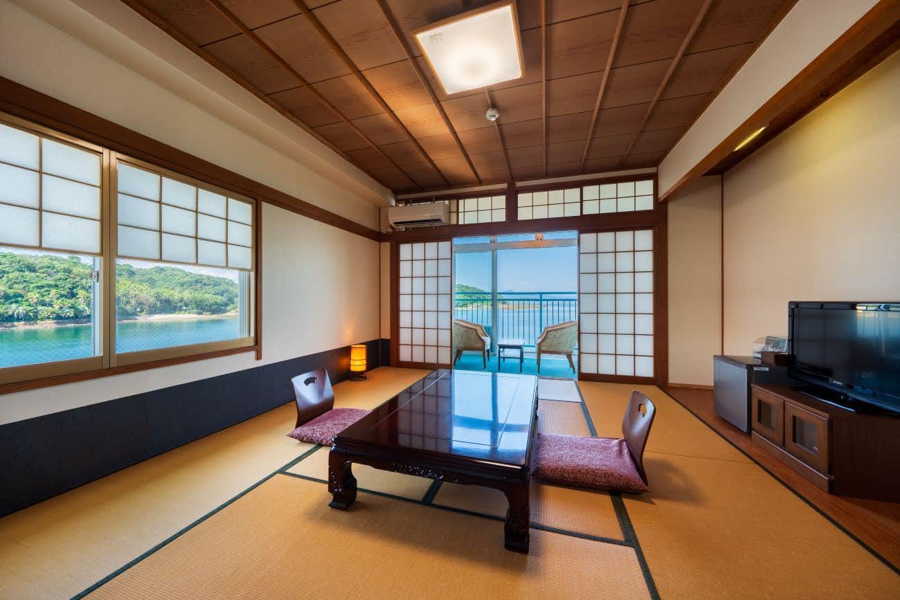 Matsushima Onsen Amakusa Nagisatei with a tatami room with low table and wide ocean windows.