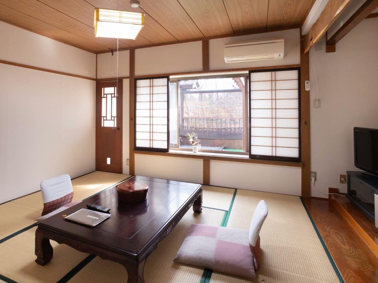 Onyado Hotakajo with a simple tatami room with dark low table.