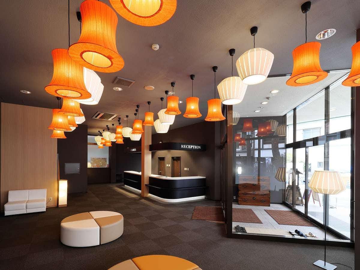 Shiobara Onsen Tokiwahotel with a modern lobby with orange pendant lights and circular seating.