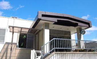 The building entrance with steps and railings.