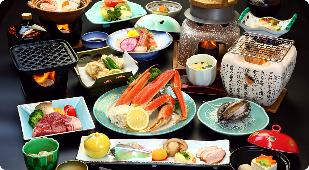A plated meal includes crab, vegetables, and several small bowls.