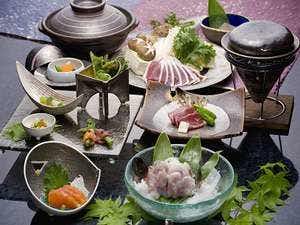 Relaxing Inn Sawemon with a Japanese dinner arranged across dark bowls and glass dishes.