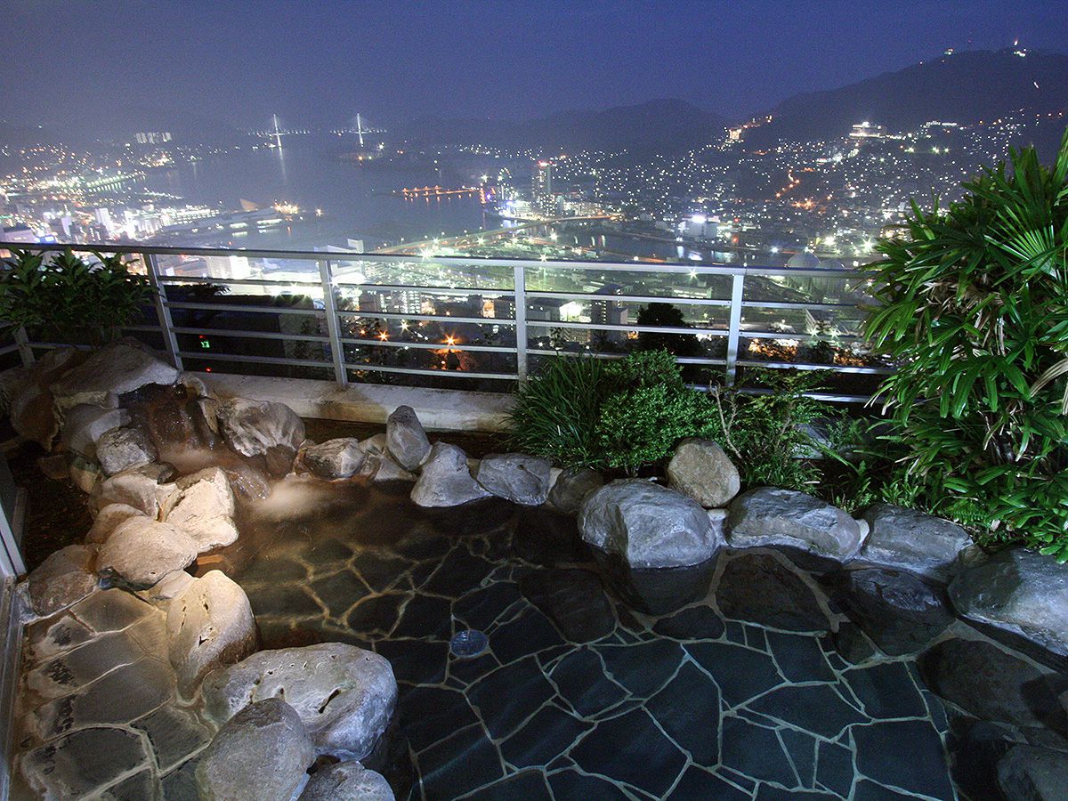 An open-air bath above Nagasaki city lights.