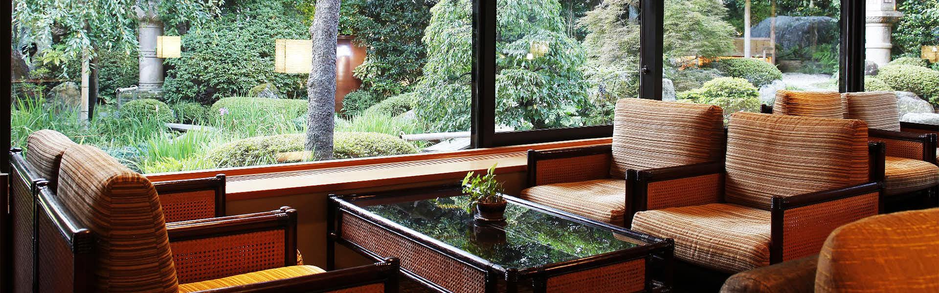 Kasuien Minami with a quiet garden lounge with sofas beside broad windows.