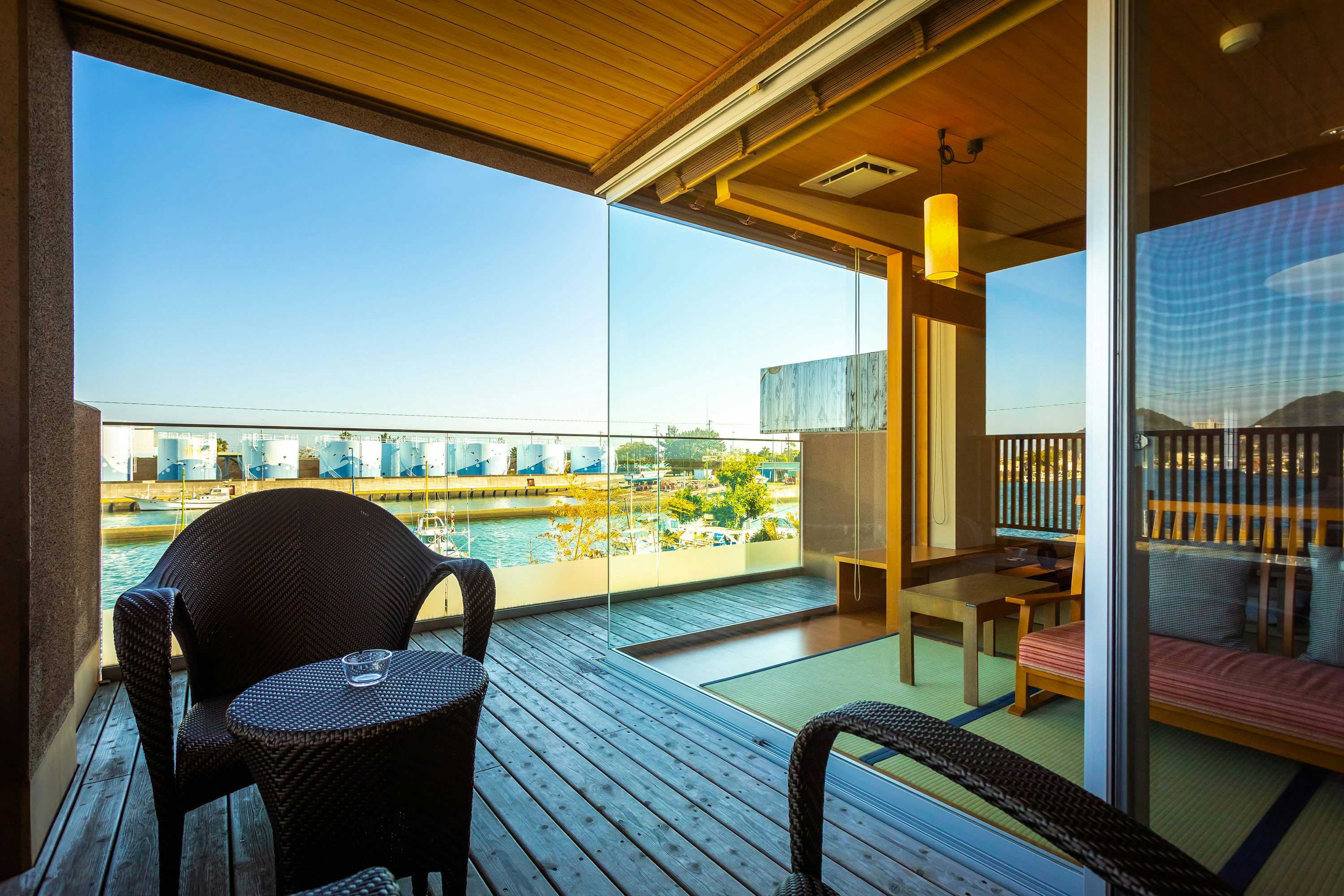 Migiwaya terrace seating beside broad harbor and blue-sky views