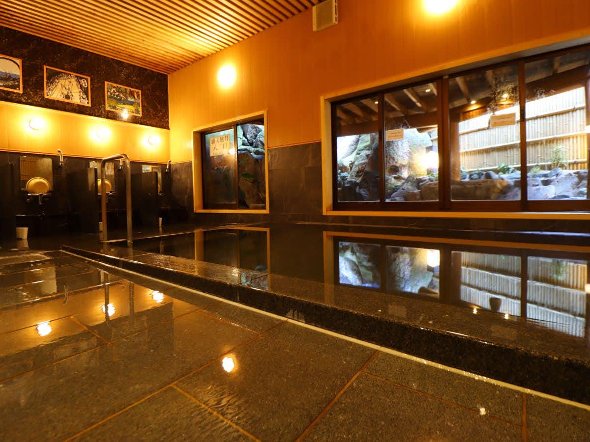 Akayu Onsen Taisho Romantic Healing Accommodation - Tanbakan with a polished indoor bath reflecting warm ceiling lights.