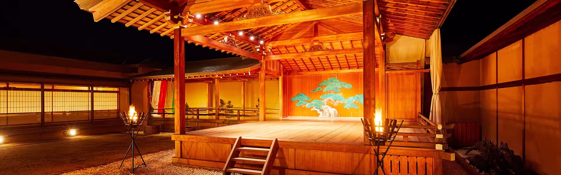 Yamatoya Honten with this scene, where its illuminated Noh stage displays a painted pine backdrop.