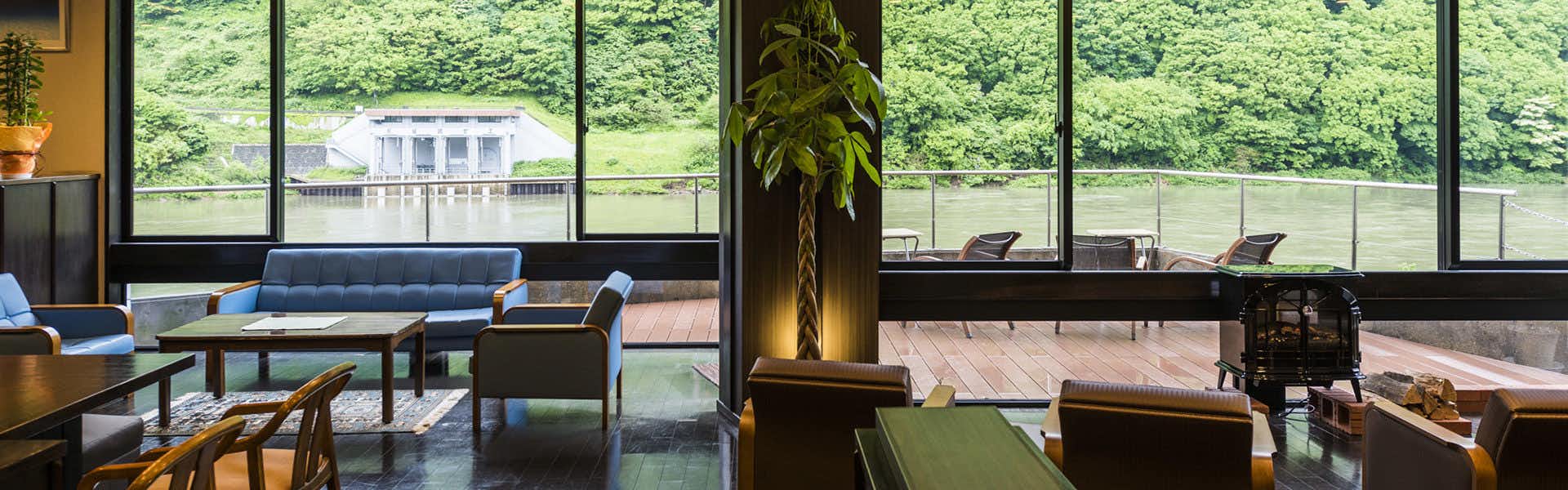 Takamiya Mogamigawa Villa Beni with a contemporary lounge facing broad river windows.