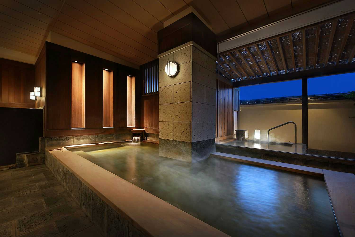 Atami Onsen Sakuraya Ryokan Rectangular pool with wood-paneled walls, large window opening, and interior lighting fixtures.