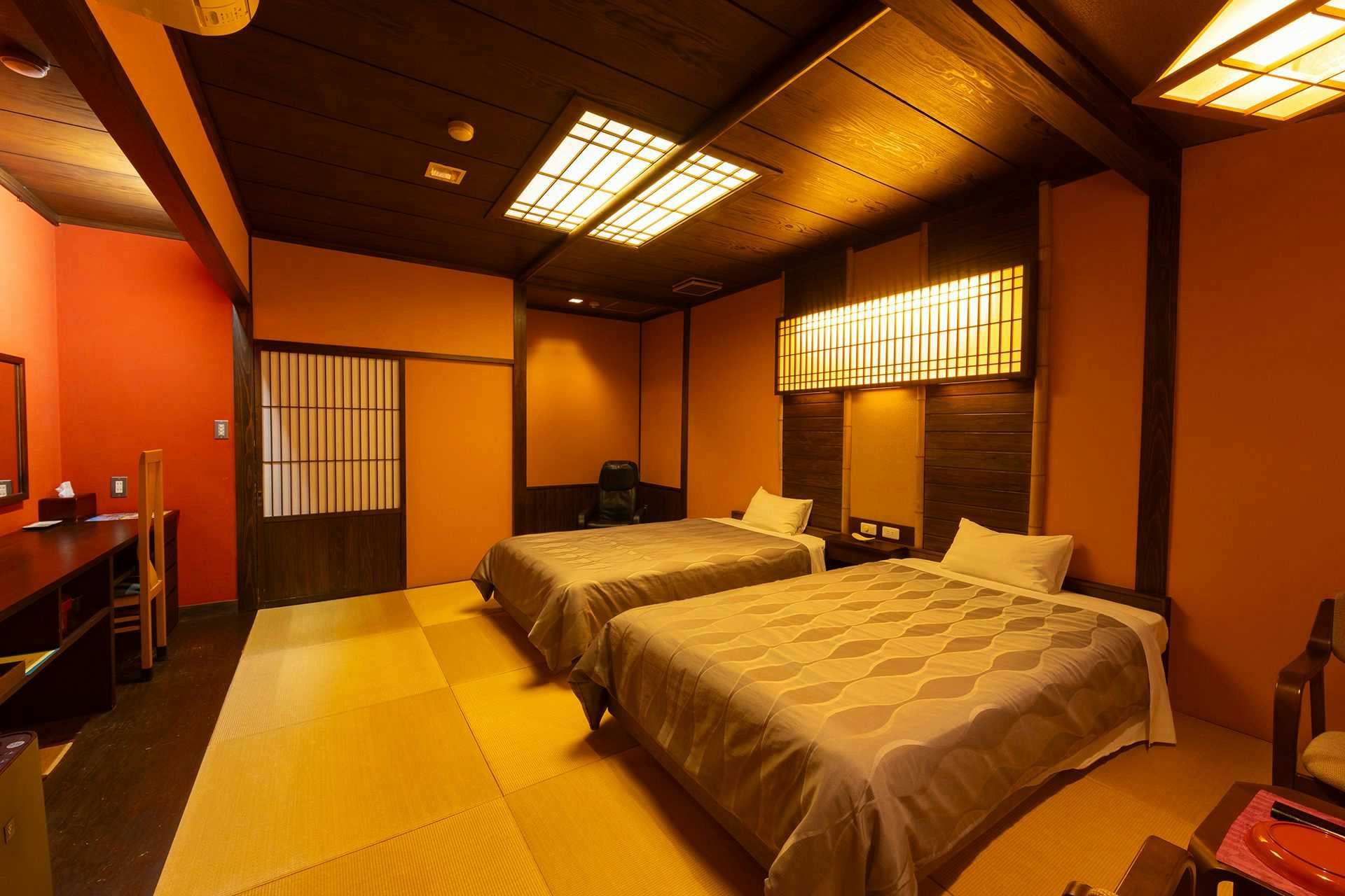 Saikatei Jidaiya with a bright twin bedroom with pale walls and bedside seating.