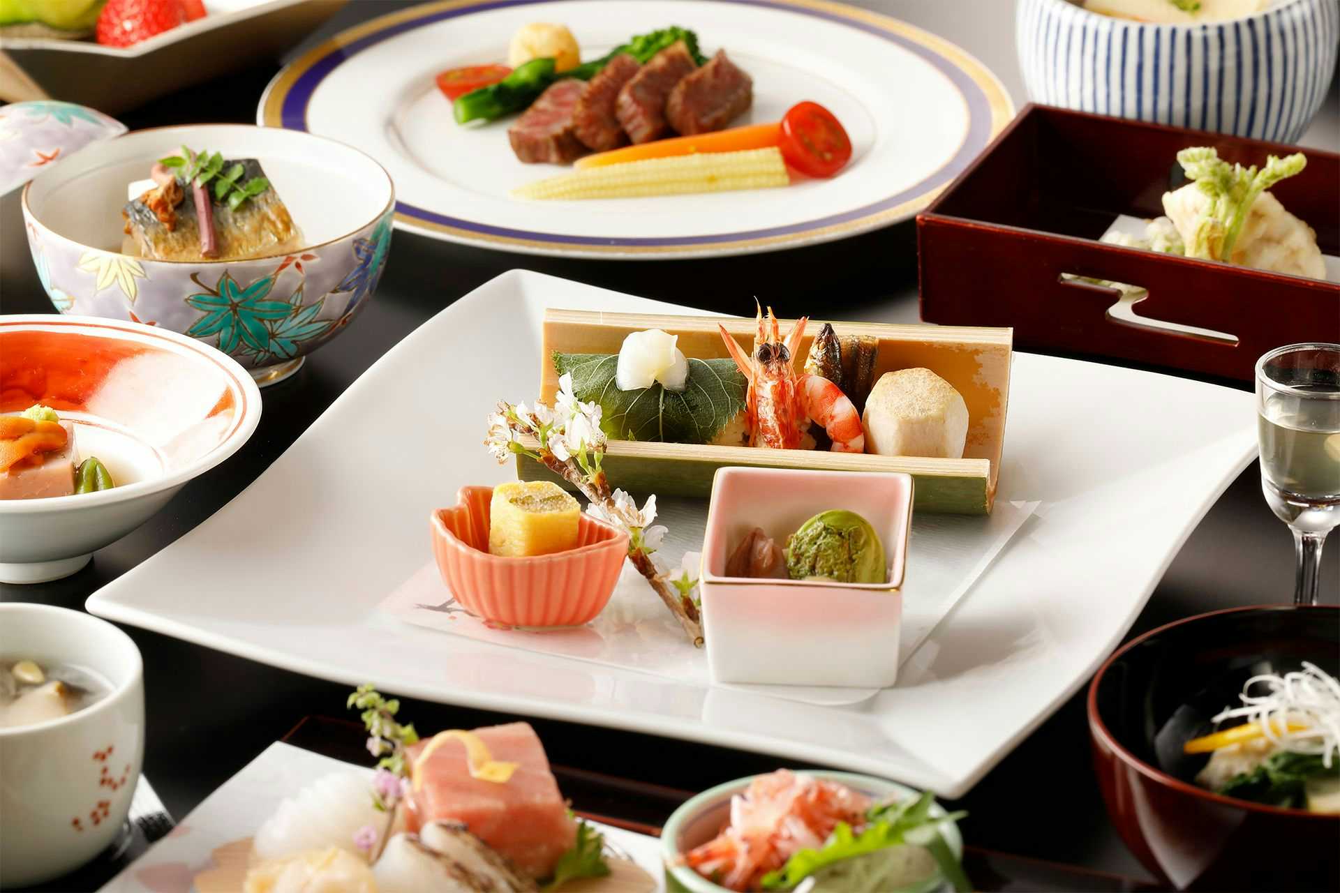 Gora Onsen Private Hot Spring Inn Gora Kansuirou with a multicourse Japanese dinner arranged across white and lacquered tableware.