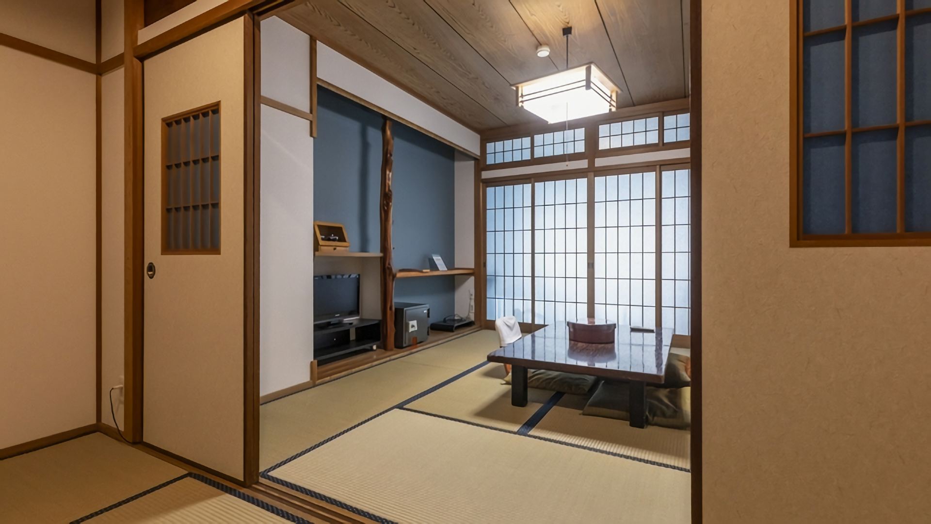 A tatami room with a television and low table.