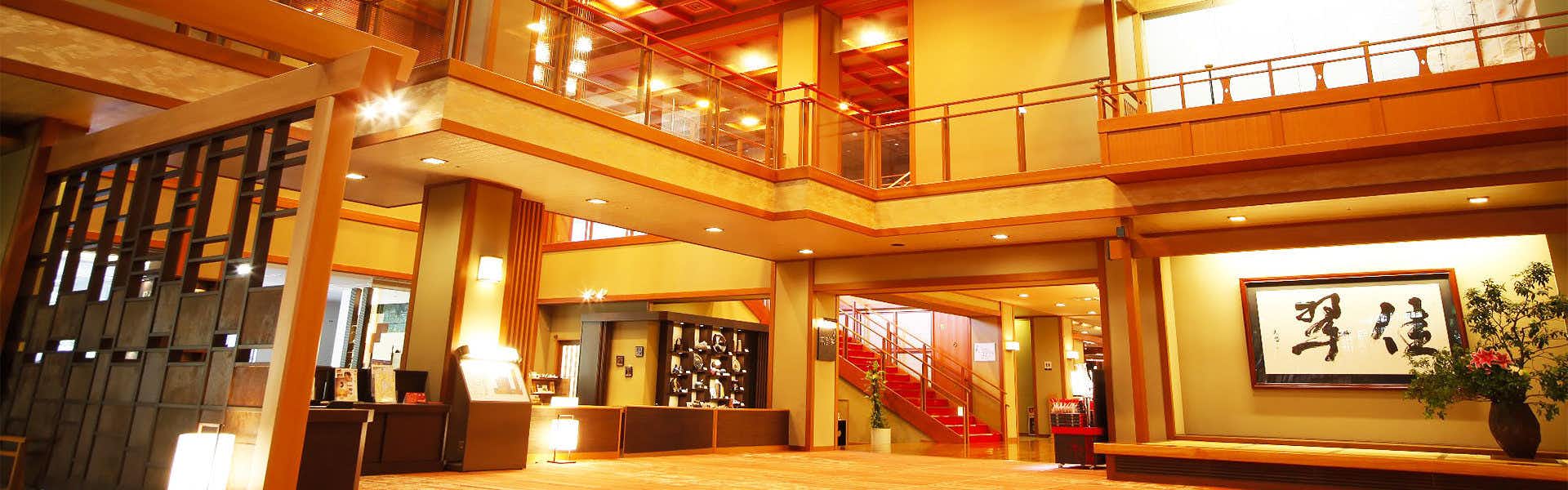 Kasuien Minami with a warm timber lobby centered on a calligraphy display.