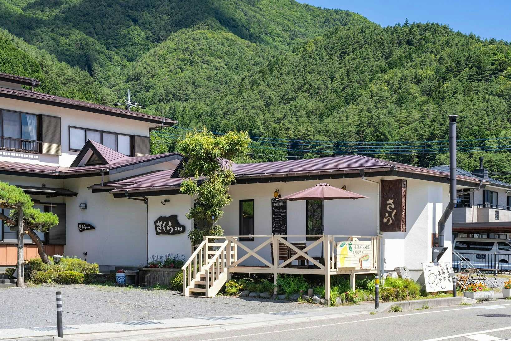 Kappo Nagahama Ryokan with an antique chest and clock arranged beneath the property sign.