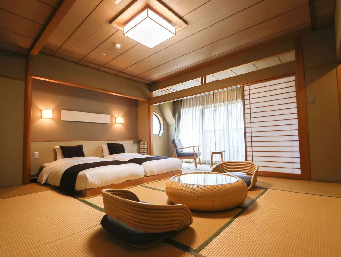 A bedroom combines two beds, a low table, and sliding screens.