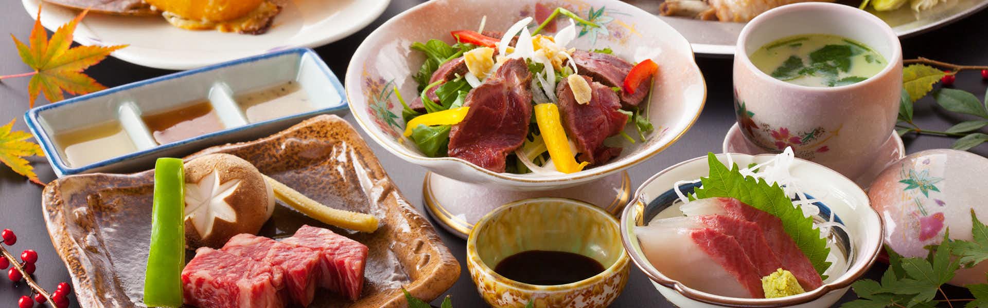 Yasuragi no Yado Matsuya with a Japanese dinner arranged across patterned ceramic dishes.
