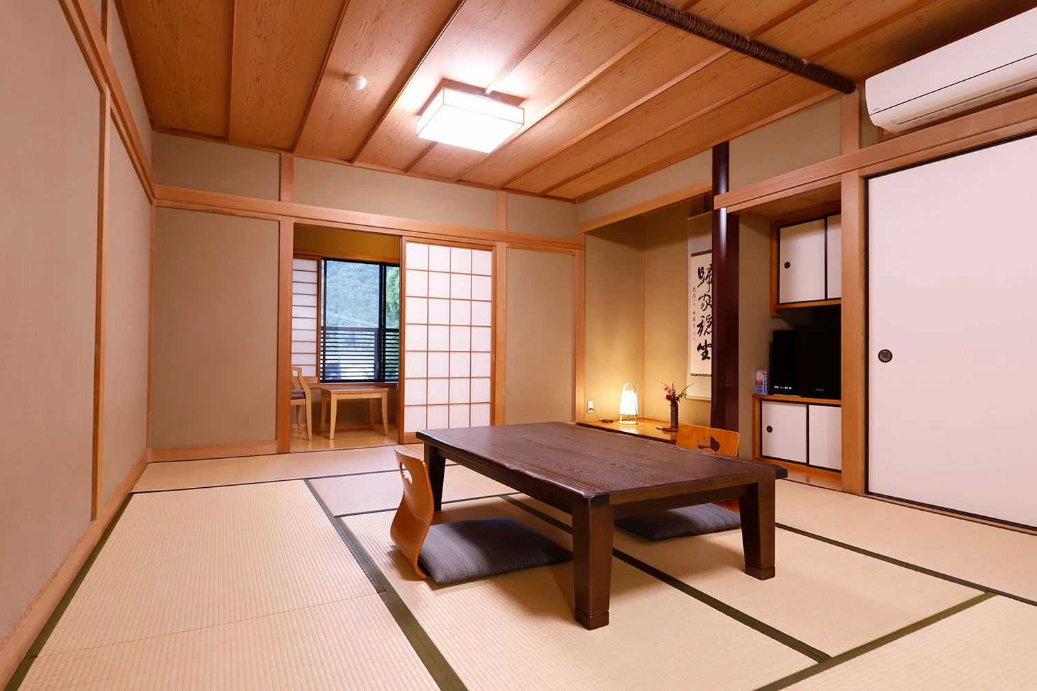 Yufuin Onsen Onyado Nakaya with a spacious tatami room with low table and shoji screens.