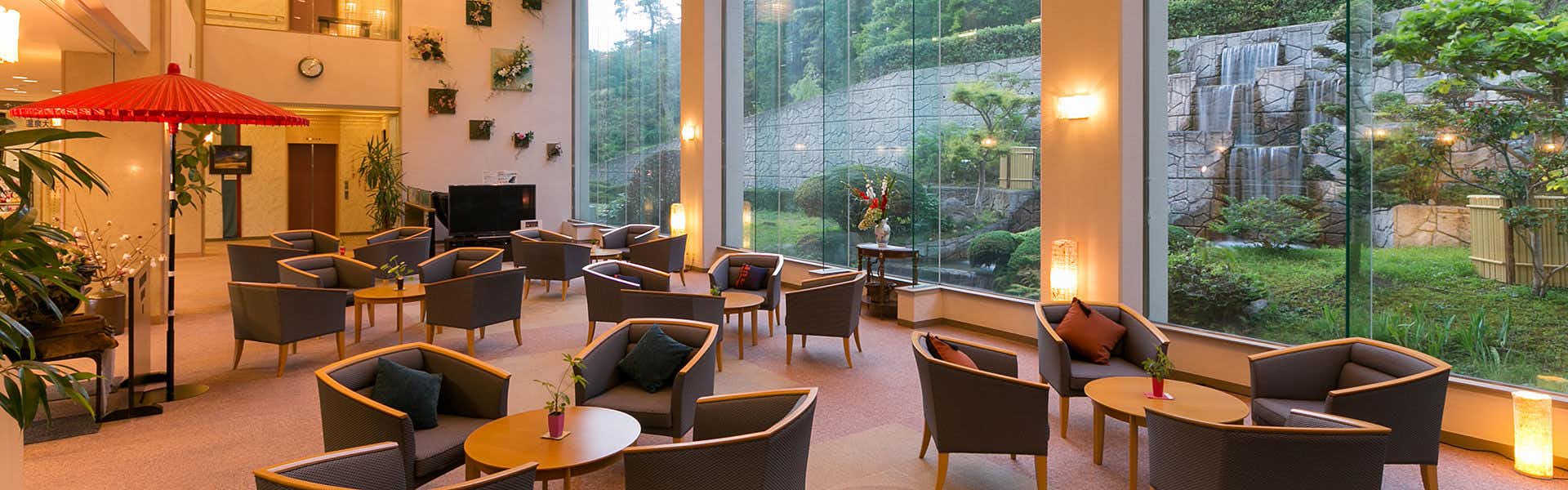 Sahimeno Inn of the Four Seasons with a spacious lobby with black seating and tall garden windows.