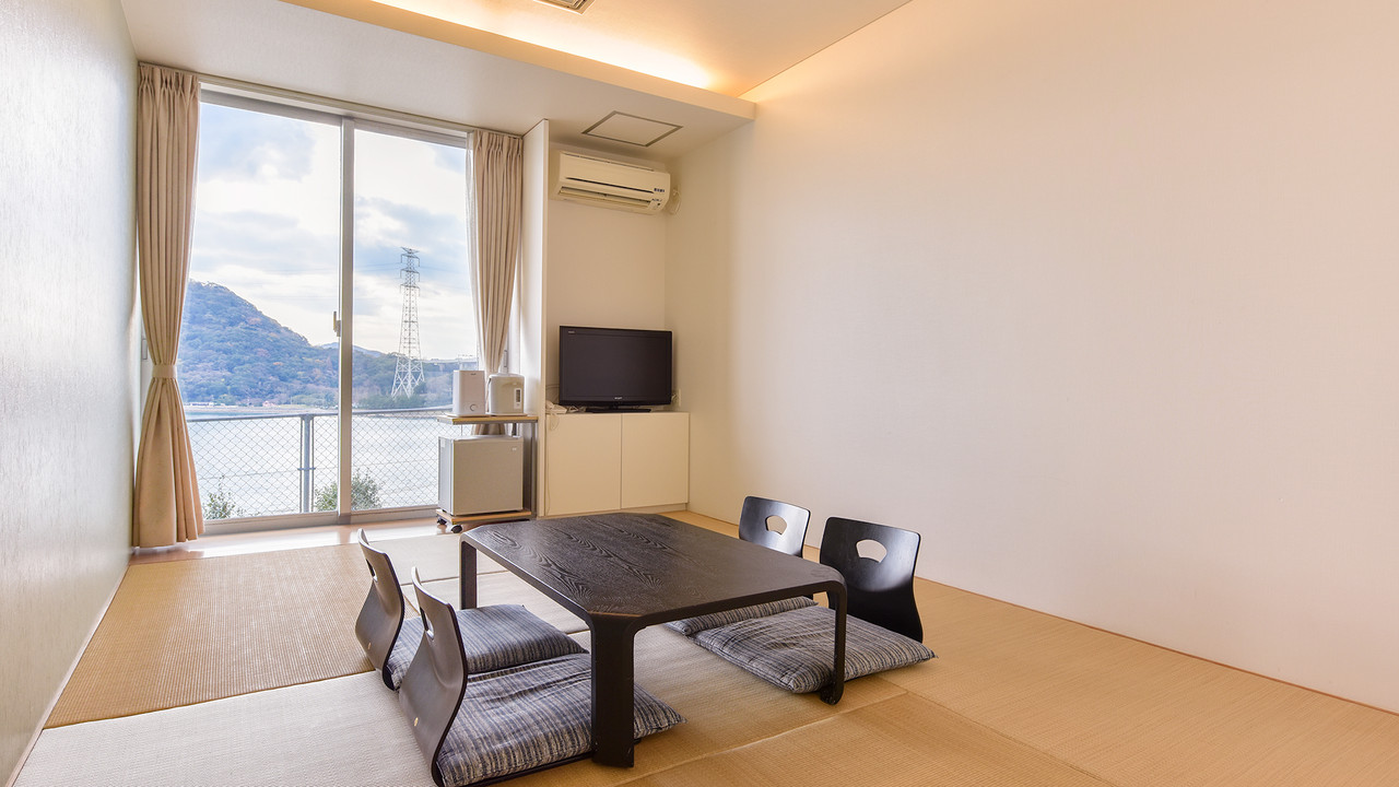 Tatami room with a table and mountain view.