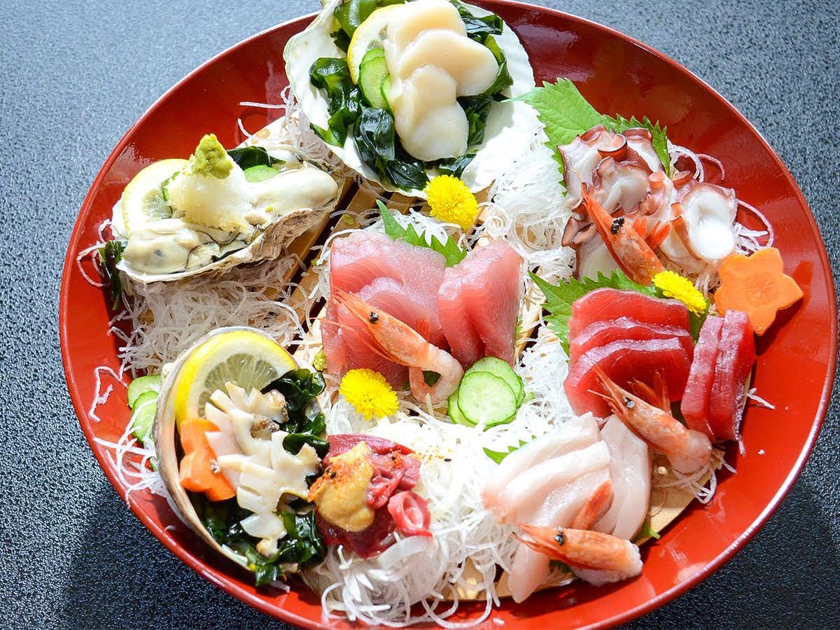 Ryokan Kaikokan with fresh sashimi arranged on a large red platter.
