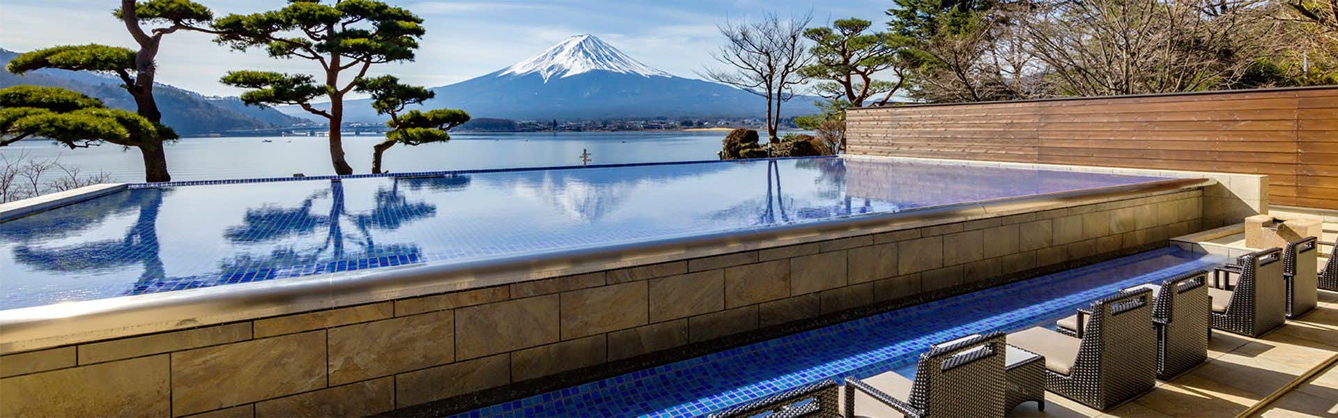 Shuhokaku Kogetsu a broad outdoor bathing pool facing a lake and mountain.