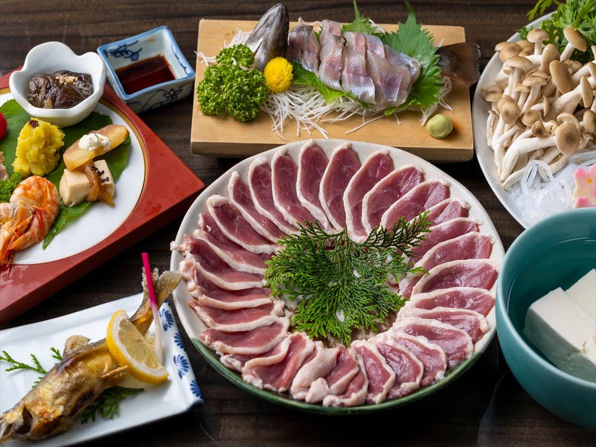 Ryokan Kinokuniya Jinpachi with fresh sashimi and sliced fish presented on ceramic platters.