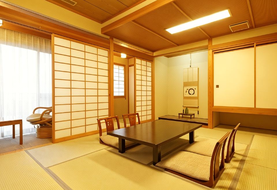 A tatami guest room with a low table and floor chairs.