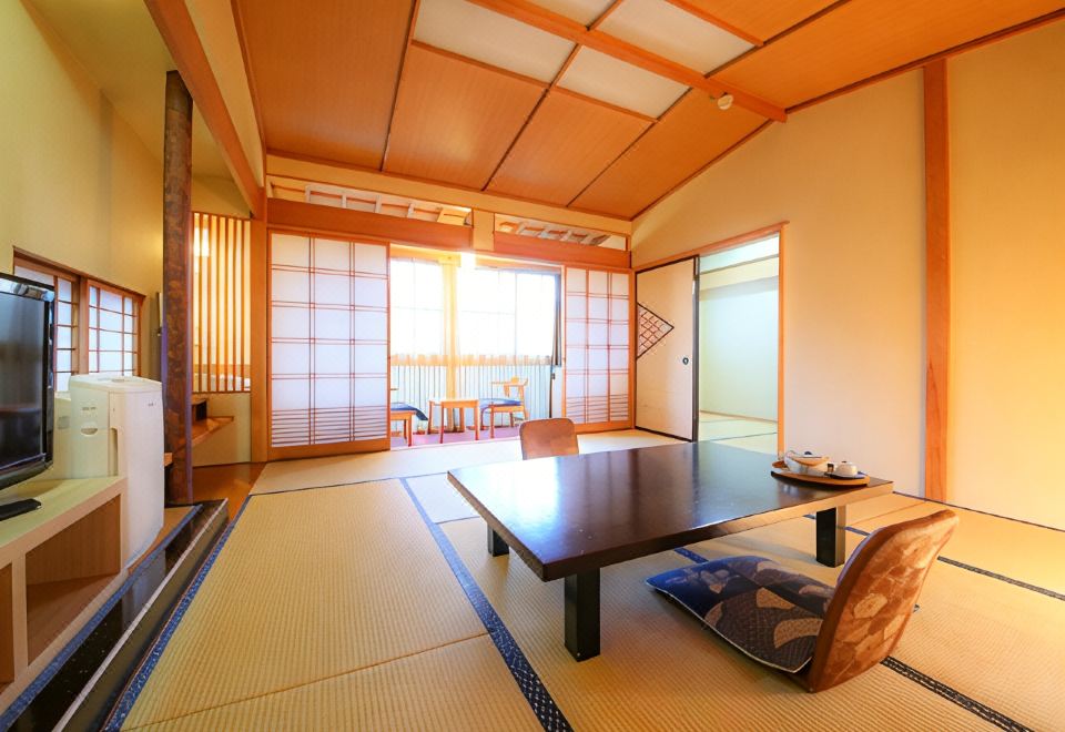 A tatami room with a low table and television.