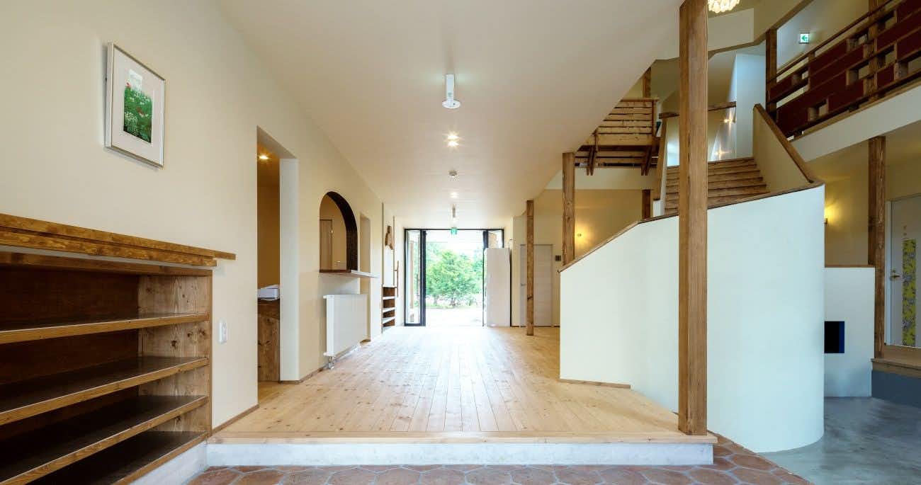 Toyotomi Onsen Kawashima Ryokan with a bright timber corridor with arched doorways and open shelving.