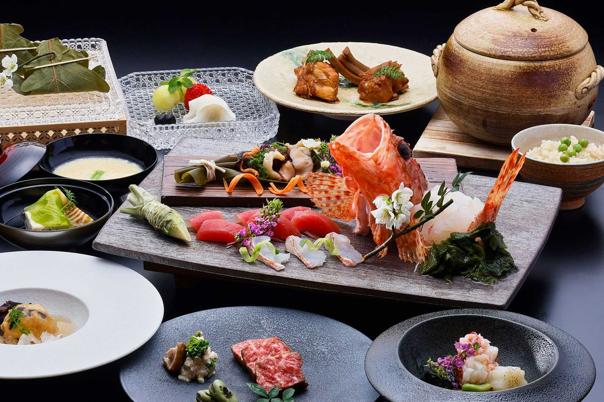Aoki Shima no Yado Kumano Bettei Nakanoshima Meal arrangement across ceramic plates and bowls with a large decorated central platter and a round lidded vessel