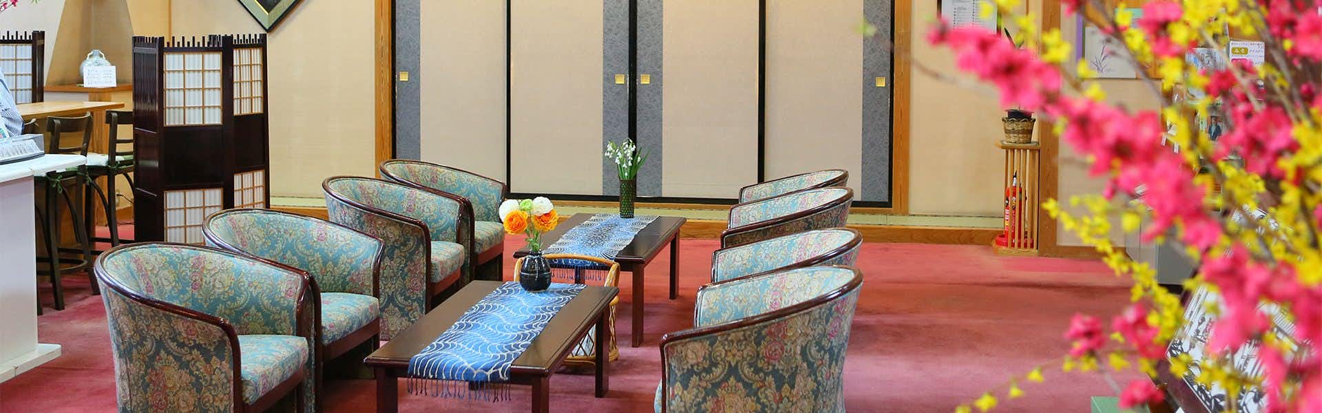 Togura Kamiyamada Onsen Ogiwara-kan with a welcoming lounge furnished with patterned armchairs.