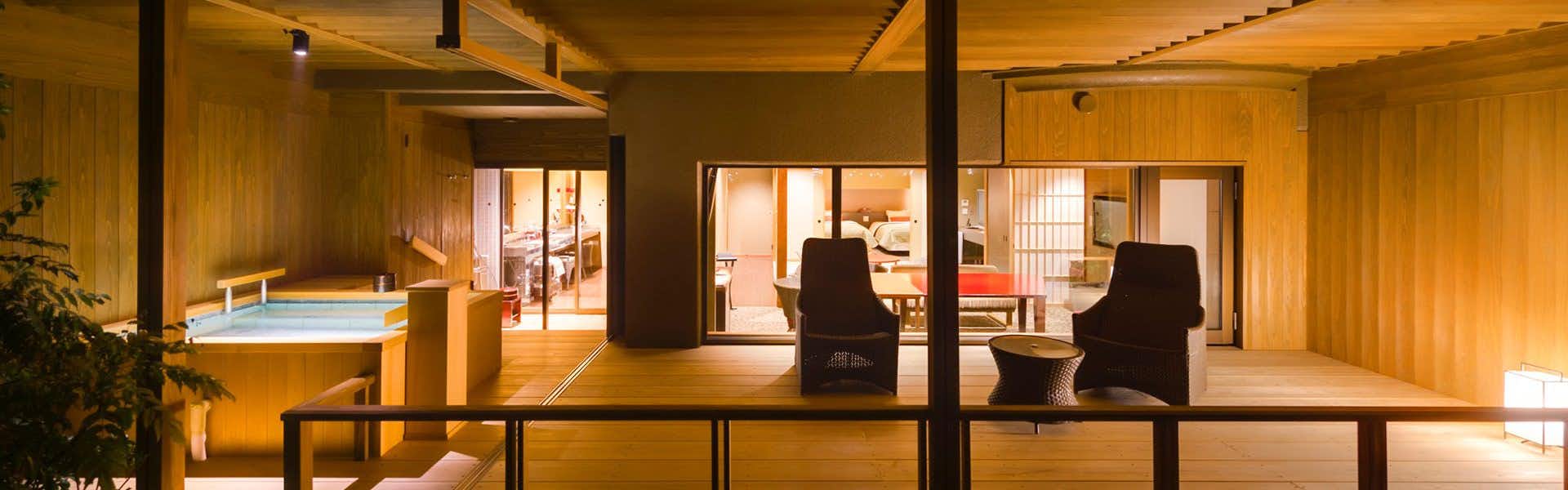 Bessho Sasa wood terrace with a rectangular bath, woven chairs and the room beyond