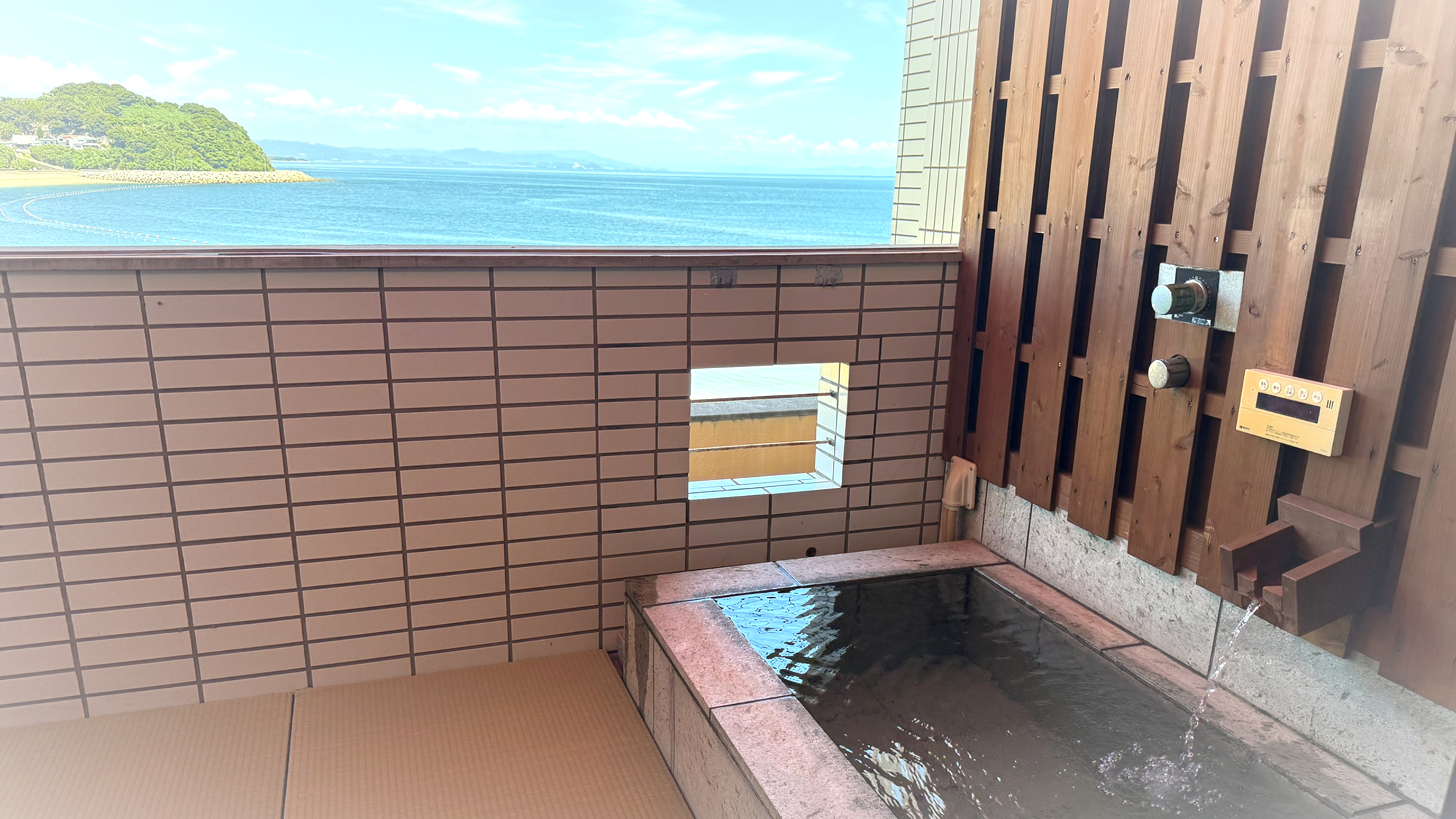 A private open-air bath overlooking the blue island coastline.